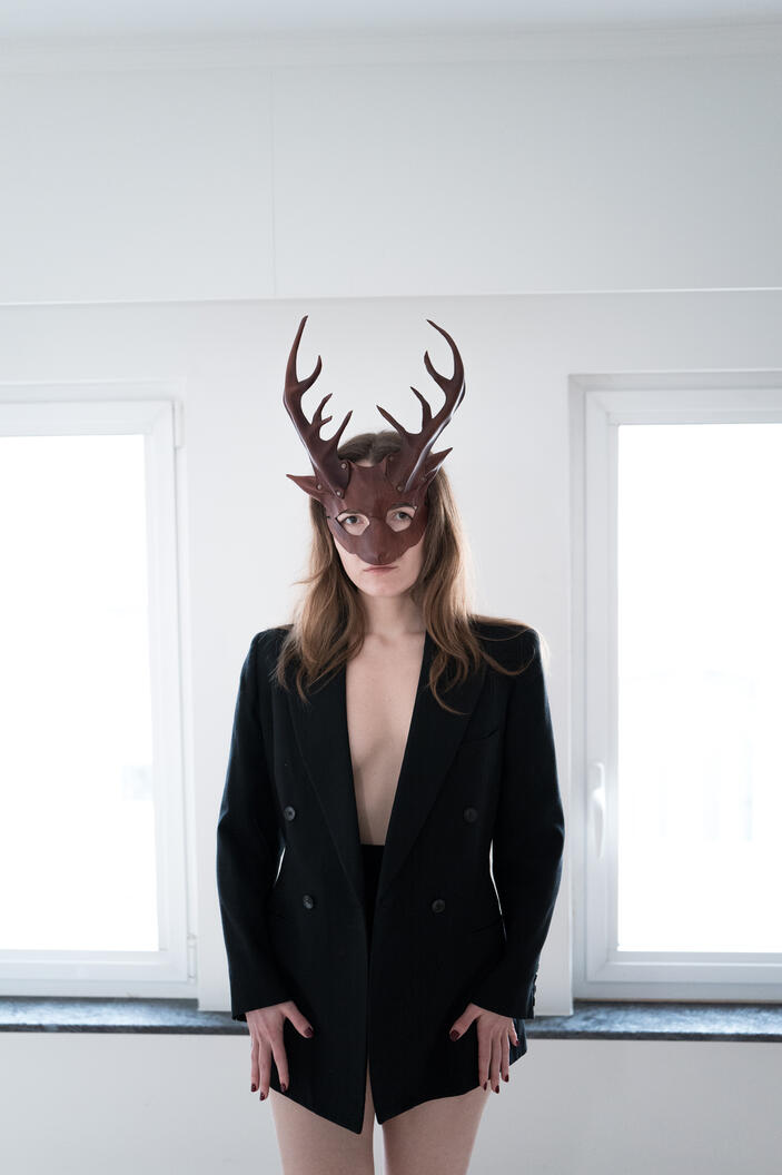 Untitled photograph, female figure, mask, interior, window light