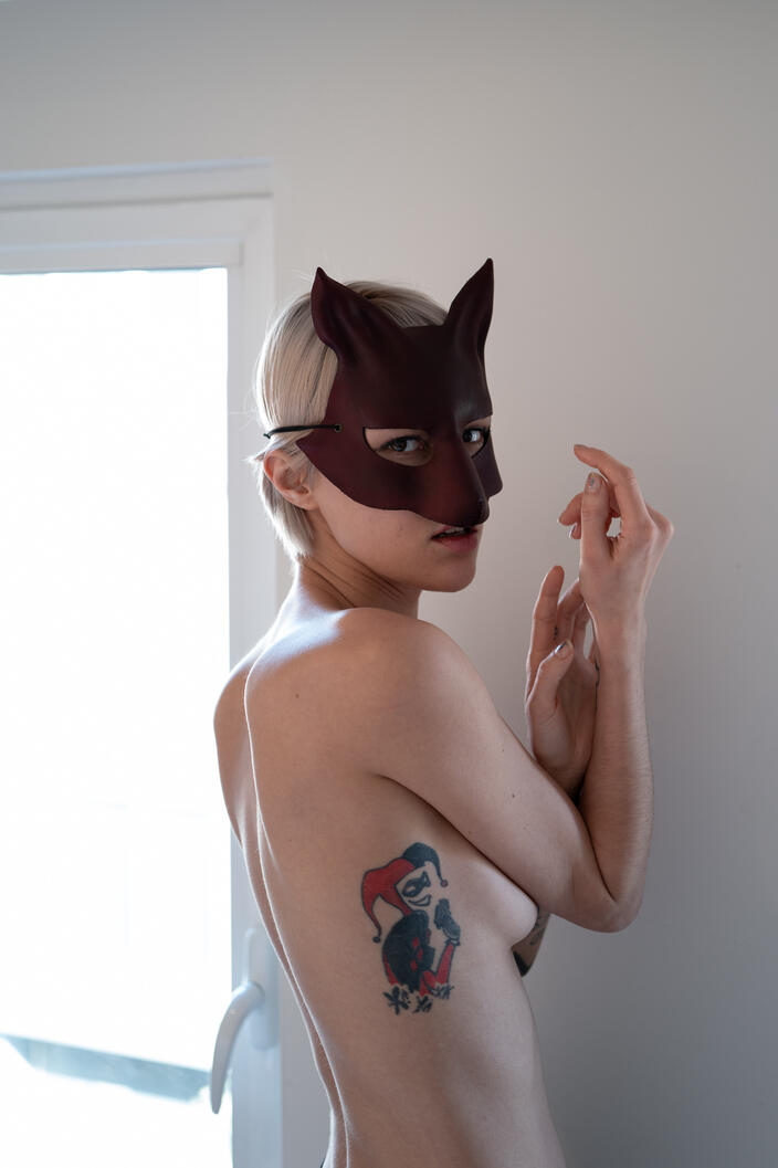 Untitled photograph, female figure, mask, interior, natural light