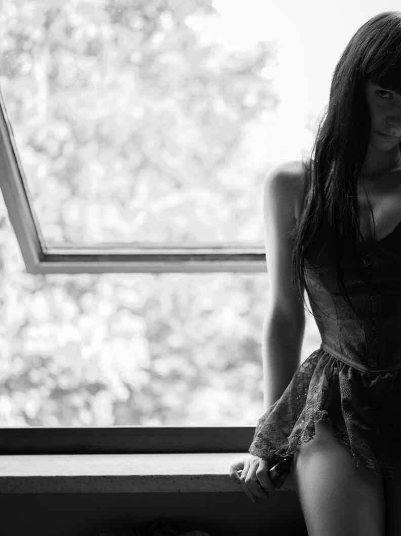 Untitled photograph, girl, interior, window light, standing